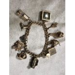 A 9CT GOLD CHARM BRACELET ELEVEN CHARMS ATTACHED EACH MARKED 9CT GOLD WEIGHT 33.7G