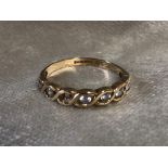 A 9CT GOLD FANCY RING HAVING CZ STONES ACROSS TOP RING SIZE R 1/2 (1 STONE MISSING)