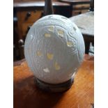 LARGE HAND CARVED AFRICAN OSTRICH EGG DEPICTING AN ELEPHANT AND GIRAFFE ON WOODEN PLINTH GOOD