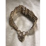 A 9CT GOLD SEVEN BAR GATE BRACELET WEIGHT 15.5G