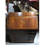 REPRODUCTION GEORGIAN STYLE MAHOGANY BUREAU WITH DECORATIVE INLAY AND BRASS HANDLES RAISED ON PLINTH