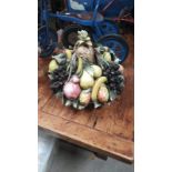 A LARGE MAJOLICA FRUIT IN A BASKET AS FOUND
