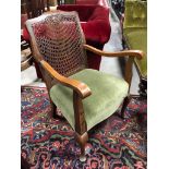 ANTIQUE WICKER BACKED ARM WITH GREEN VELVET UPHOLSTERY