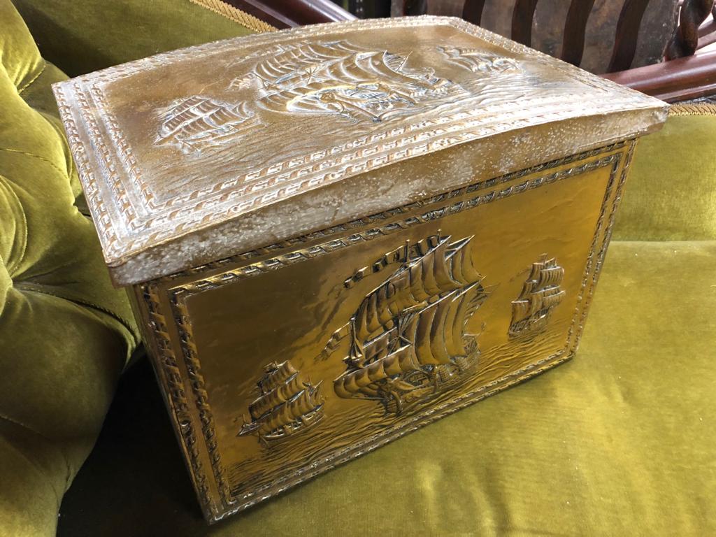 AN OLD BRASS WRAPPED DOME TOP COAL BOX WITH EMBOSSED ENGLISH GALLIONS AT FULL MASK