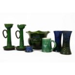 Seven pieces of Art pottery, a pair of Brannam candlesticks, a pair of vases, a jardinièreand an