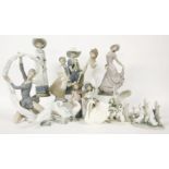 A large collection of Nao and Lladro figurines, together with further porcelain figurines.