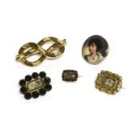 A collection of Georgian and later brooches, to include a gold memorial brooch glazed locket to