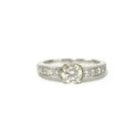 A single stone brilliant cut diamond ring, with ten brilliant cut grain set diamond shoulders, to