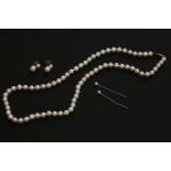 A single row uniform cultured pearl necklace, with brushed gold safety clasp, together with a pair