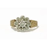 A 9ct gold illusion set diamond cluster ring, with diamond cut shoulders, 19833.26g