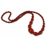 A single row graduated cherry coloured olive shaped Bakelite bead necklace,64.46g