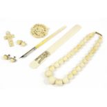 A late 19th century single row graduated ivory bead necklace, a 19th century ivory page turner