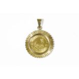 A one tenth Krugerrand coin, dated 1985, claw set in a gold pendant mount, marked 3755.09g