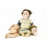 A Heubach Koppelsdorf 309.7 bisque headed doll, together with a German porcelain headed doll