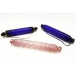 A Thomas Webb blue glass rolling pin, together with a blue glass rolling pin, a Nailsea pink and