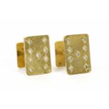 A pair of gold cufflinks, in the form of playing cards, nine of diamonds to the front, grain set
