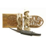 Carved driftwood ethnic bust, carving of a boy playing the flute, two carved hardwood panels and a