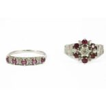 An 18ct white gold illusion set diamond and ruby cluster ring, with textured shoulders, and a 9ct