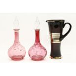 A pair of 19th century ruby glass decanters, and an art deco glass jug