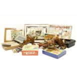 A box of old puzzles and games, including 'Old Daddy Tin Whiskers and the Magic Ring' blow football,