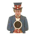 An Uncle Sam fairground sign,20th century, an unusual American painted cast metal advertising sign,