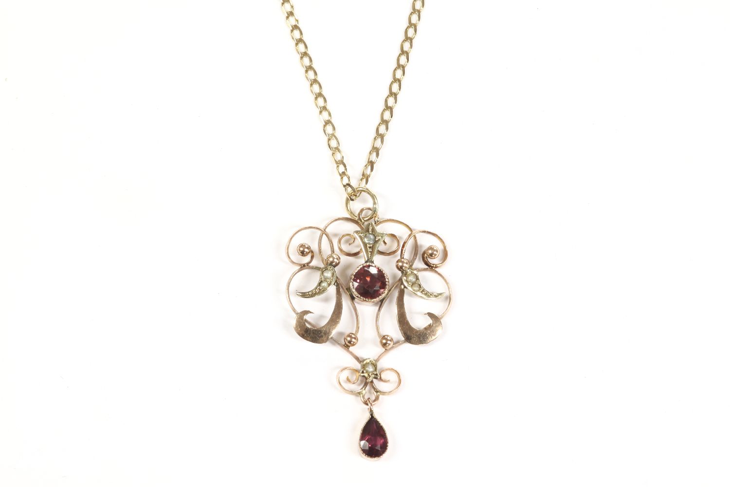 An Edwardian gold garnet and split pearl pendant, marked 9ct, on a ...