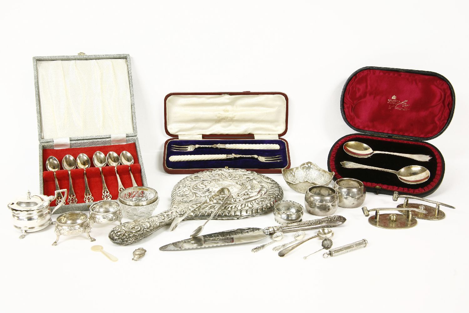 A quantity of silver cruet items, together with napkin rings, a hand mirror, a cased set of pickle