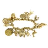 An Italian gold hollow trace link bracelet, with seventeen assorted gold charms, to include a 1909