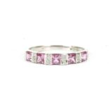 A 9ct white gold pink sapphire and diamond half eternity ring, with princess cut pink sapphires