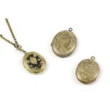 Three back and front oval lockets, including a black enamel example on a gold double belcher link
