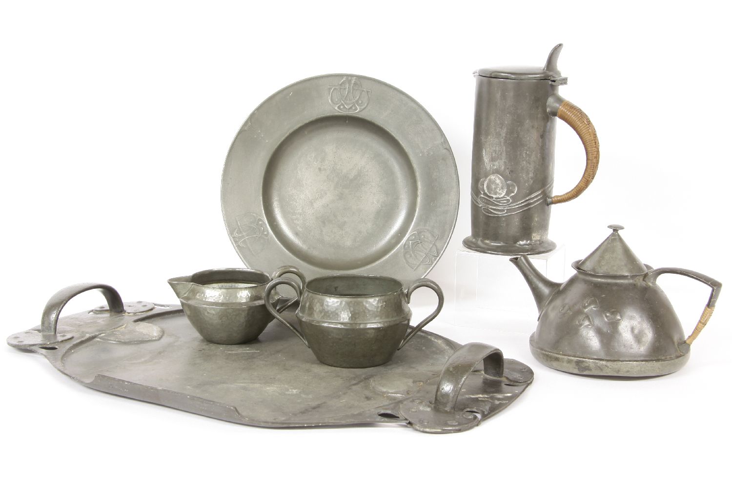 A collection of Art Nouveau pewter, to include a twin handled tray, plate, teapot a lidded jug, a