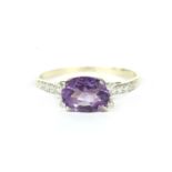 A 9ct gold single stone oval cut amethyst ring, with diamond set claws and shoulders, finger size