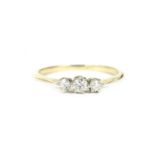 A gold three stone diamond ring, (tested as approximately 18ct gold)