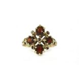 A 9ct gold four stone garnet cluster ring, finger size K½,3.74g