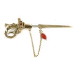 A Continental gold stick pin/hat pin in the form of a sword, with removable Scarab set with red