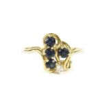 A gold circular sapphire and brilliant cut diamond spray cluster ring, marked 14k, size M½2.58g