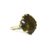 A 9ct gold mixed buff top single stone smokey coloured paste stone ring,8.89g