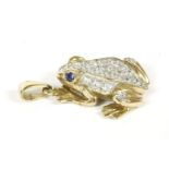 A 9ct gold colourless cubic zirconia set frog pendant, with blue cubic zirconia eyes12.84g