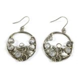 A pair of Arts & Crafts style silver circular moonstone drop earrings, rub set to scrolling vine