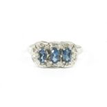 A 9ct white gold three stone blue topaz and diamond cluster ring, finger size O,2.75g