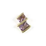 An 18ct gold two stone amethyst pendant, with two rectangular buff top amethysts, end set to