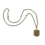 A gold back and front shield locket, with vacant cartouche, on a gold belcher chain (tested as 9ct