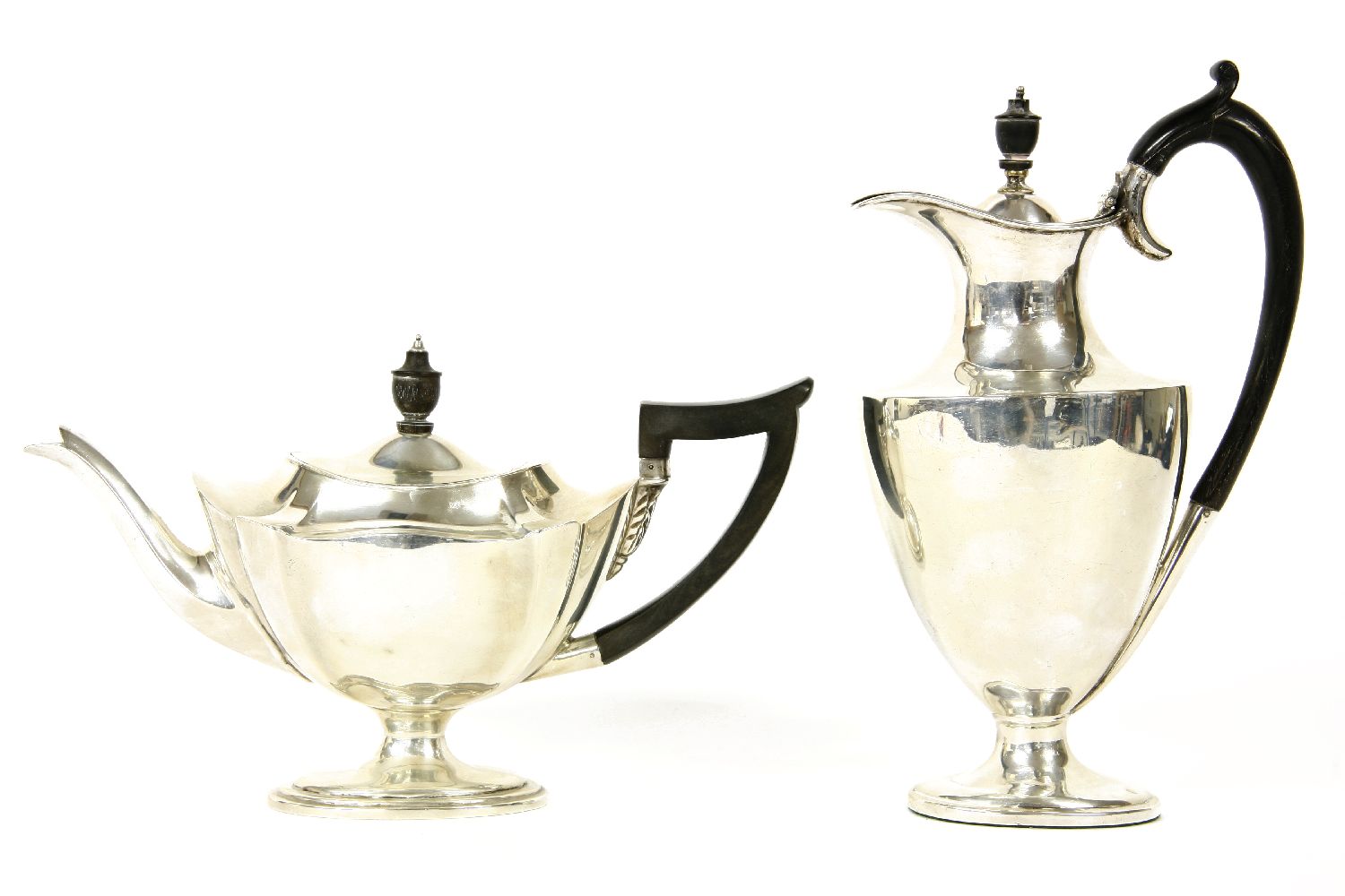 An Edwardian silver teapot of navette form, with ebony handle and finial, London 1907; together with