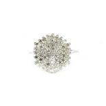 A white gold diamond set hexagonal cluster ring, (tested as approximately 9ct gold) finger size O