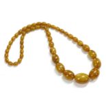 A single row graduated toffee coloured olive shaped Bakelite bead necklace, (with swirls) 62.19g