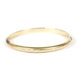 A gold hollow hinge bangle, marked 585,9.67g