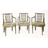 A set of three Regency period painted and ebonised elbow chairs, with pierced splat backs (3)