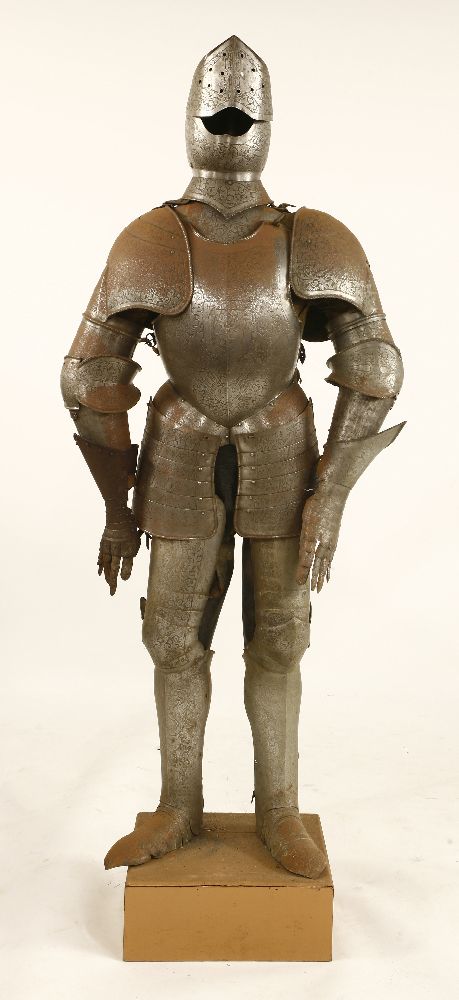 An engraved suit of armour,late 19th/early20th century, on a wooden stand,170cm high overall