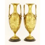 Two gilt bronze vases, with angular pierced twin handles and applied stylised flowers and insects to