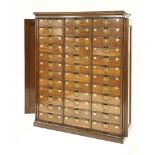 An Edwardian mahogany office cabinet, with a pair of double panelled and folding doors, and thirty-